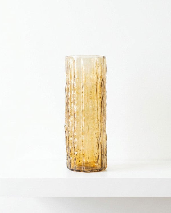Decorative vase with white flowers against a wooden background