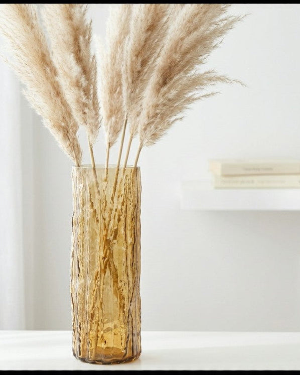 Decorative vase with white flowers against a wooden background